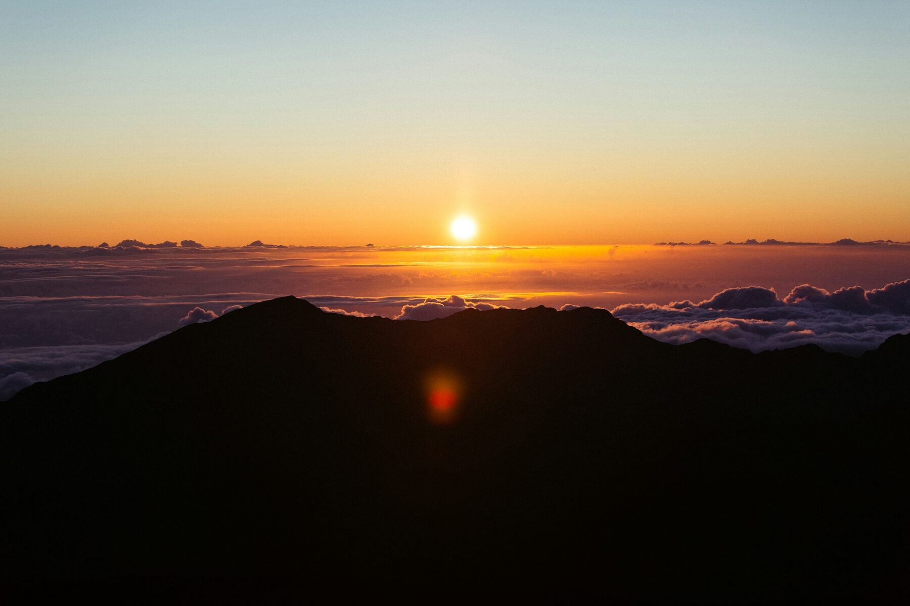 Sunrise above the clouds from the summit of Haleakalā